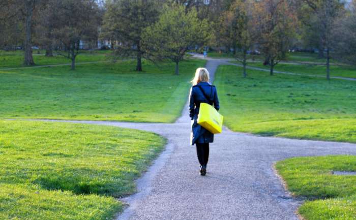 A woman walking into a crossroads